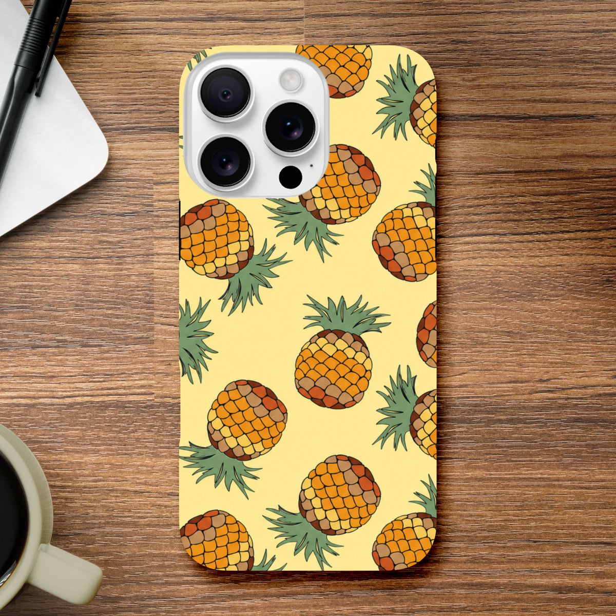 Yellow pineapple tough iPhone case featuring a tropical fruit pattern on a light yellow background for impact protection.