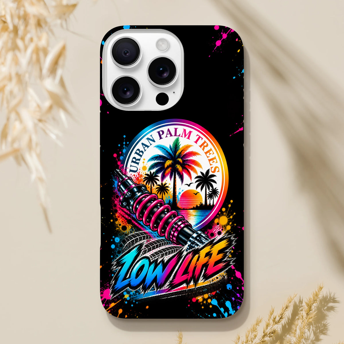 Low Life Petrolhead iPhone case featuring Urban Palm Trees art, shock absorber graphic, and colorful splatter design on black background.