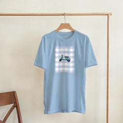 Light blue women's graphic tee featuring a retro pastel scooter on a gingham background for cute streetwear vibes.