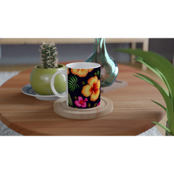 Tropical Hibiscus mug with vibrant floral pattern on a white interior, on a wooden table beside a cactus.