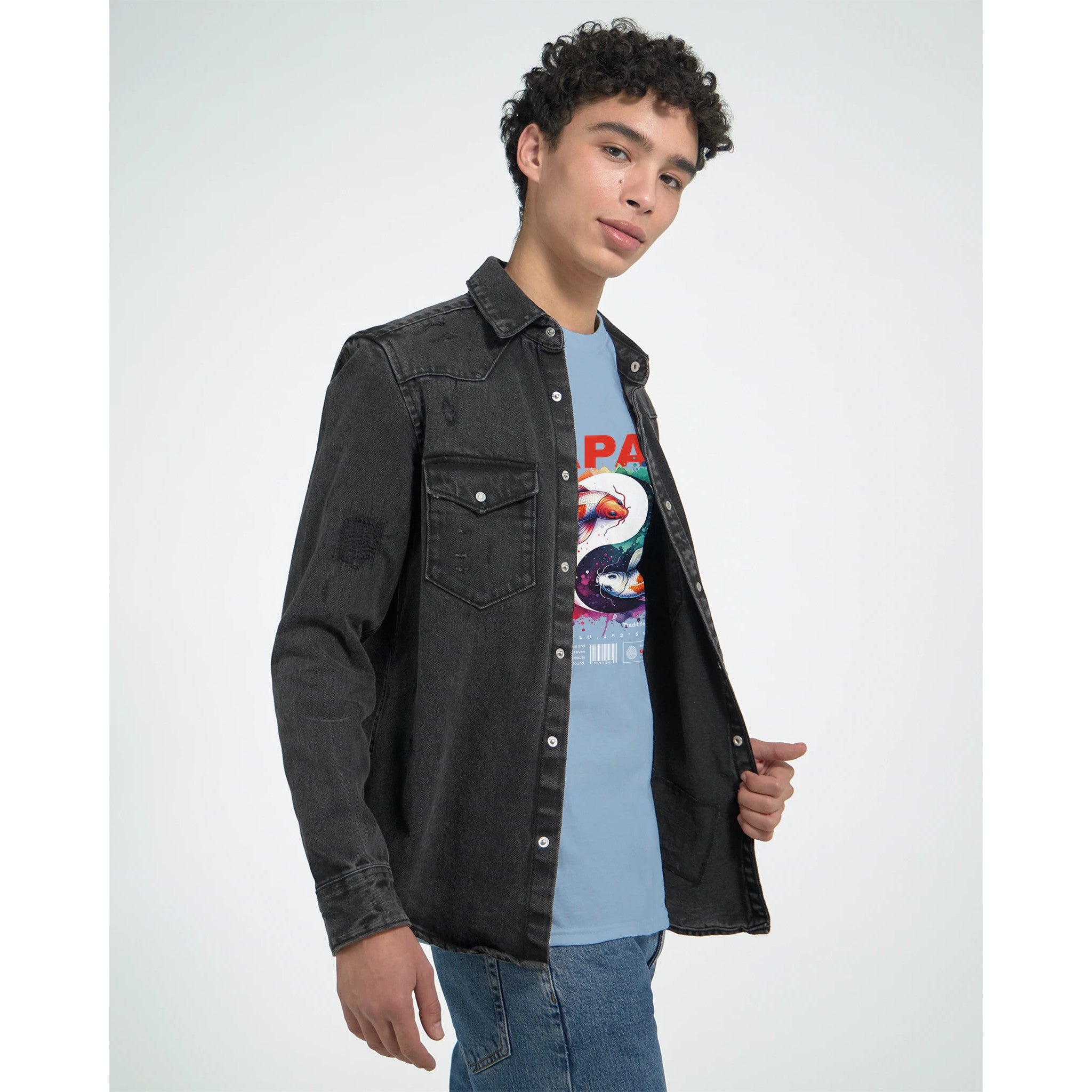 Male model wearing a black denim jacket over a blue Japanese graphic T-shirt with colorful koi artwork.