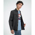 Male model wearing a black denim jacket over a blue Japanese graphic T-shirt with colorful koi artwork.