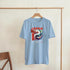 Light blue men's graphic T-shirt with red JAPAN text and a colorful koi fish graphic on the chest.