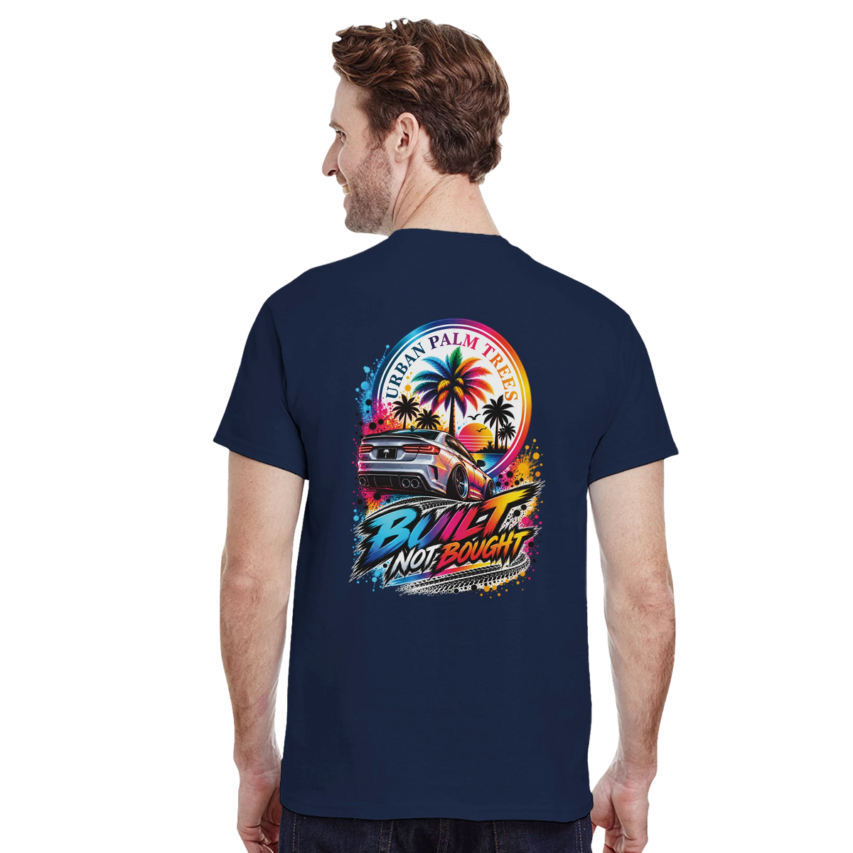 Navy t-shirt back featuring "Built Not Bought" graphic with modified car, palm trees, and colorful sunset design.