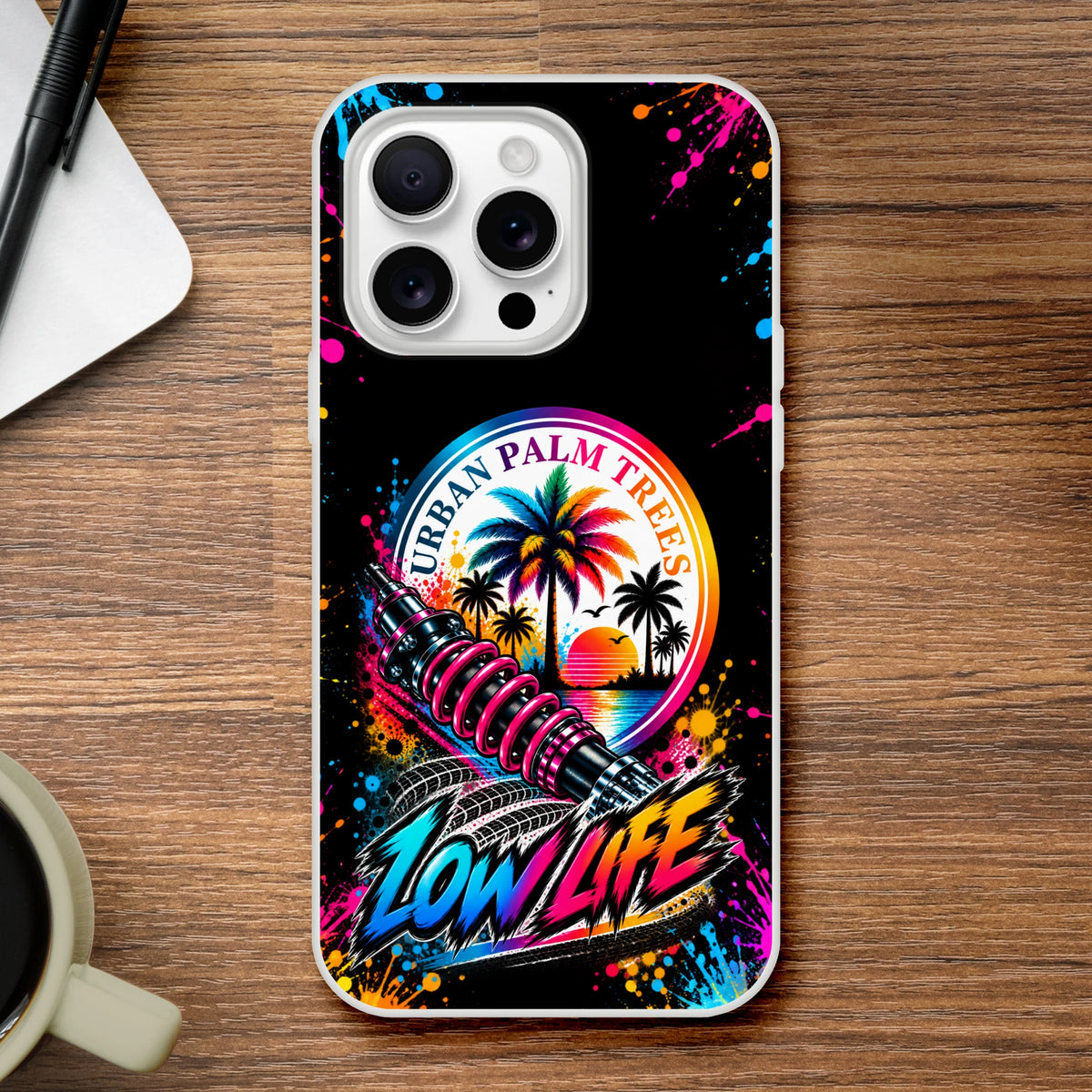 Low Life car culture iPhone case featuring Urban Palm Trees art, pink shock absorber, and colorful neon splatter design on black background.
