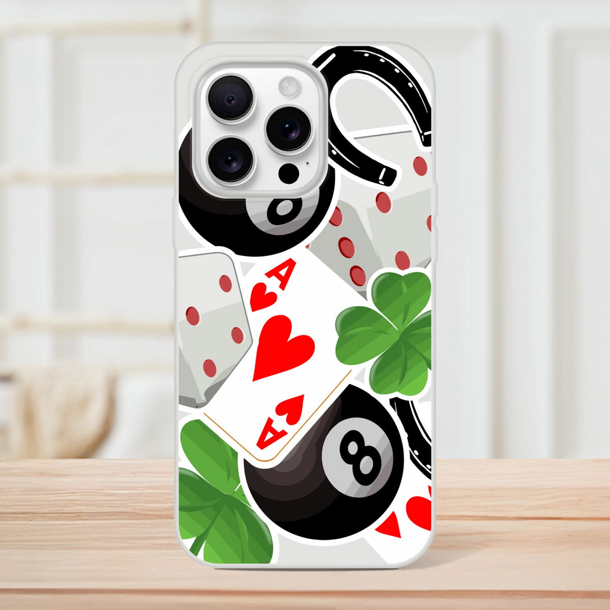Transparent iPhone case featuring lucky charm graphics including an Ace of Hearts, 8-ball, four-leaf clover, and horseshoe design.