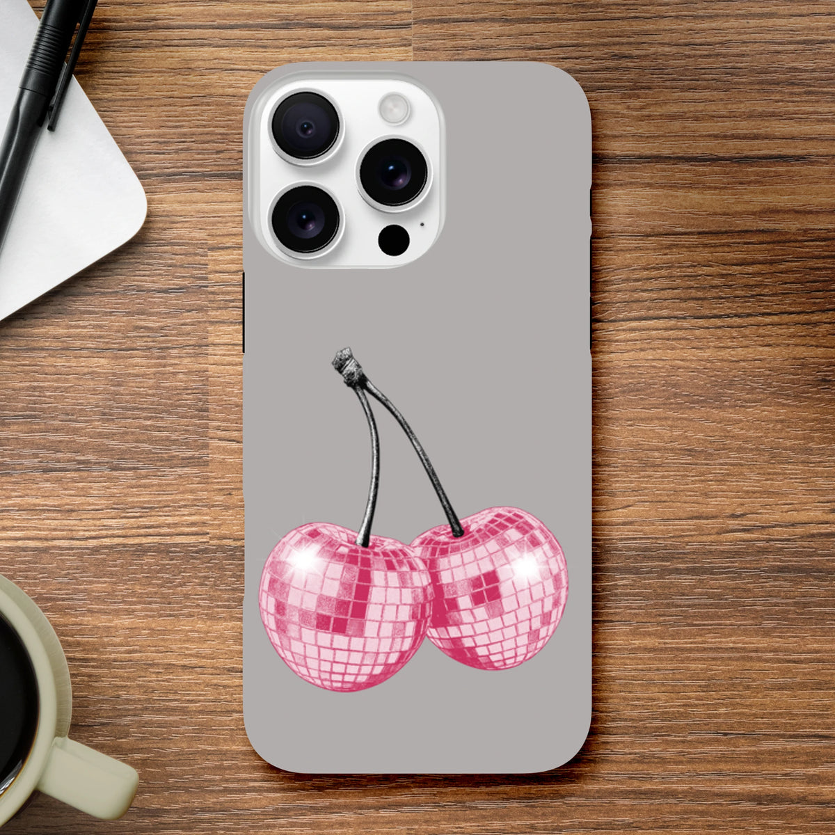 Pink glitterball cherry design on a tough grey iPhone case for models 13 through 16.