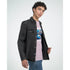 Male model wearing pink Teddy Bear graphic T-shirt under a black denim jacket.