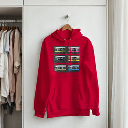 Red hoodie with stacked vintage cassette tape graphic on front, hanging on a wooden hanger in a closet.