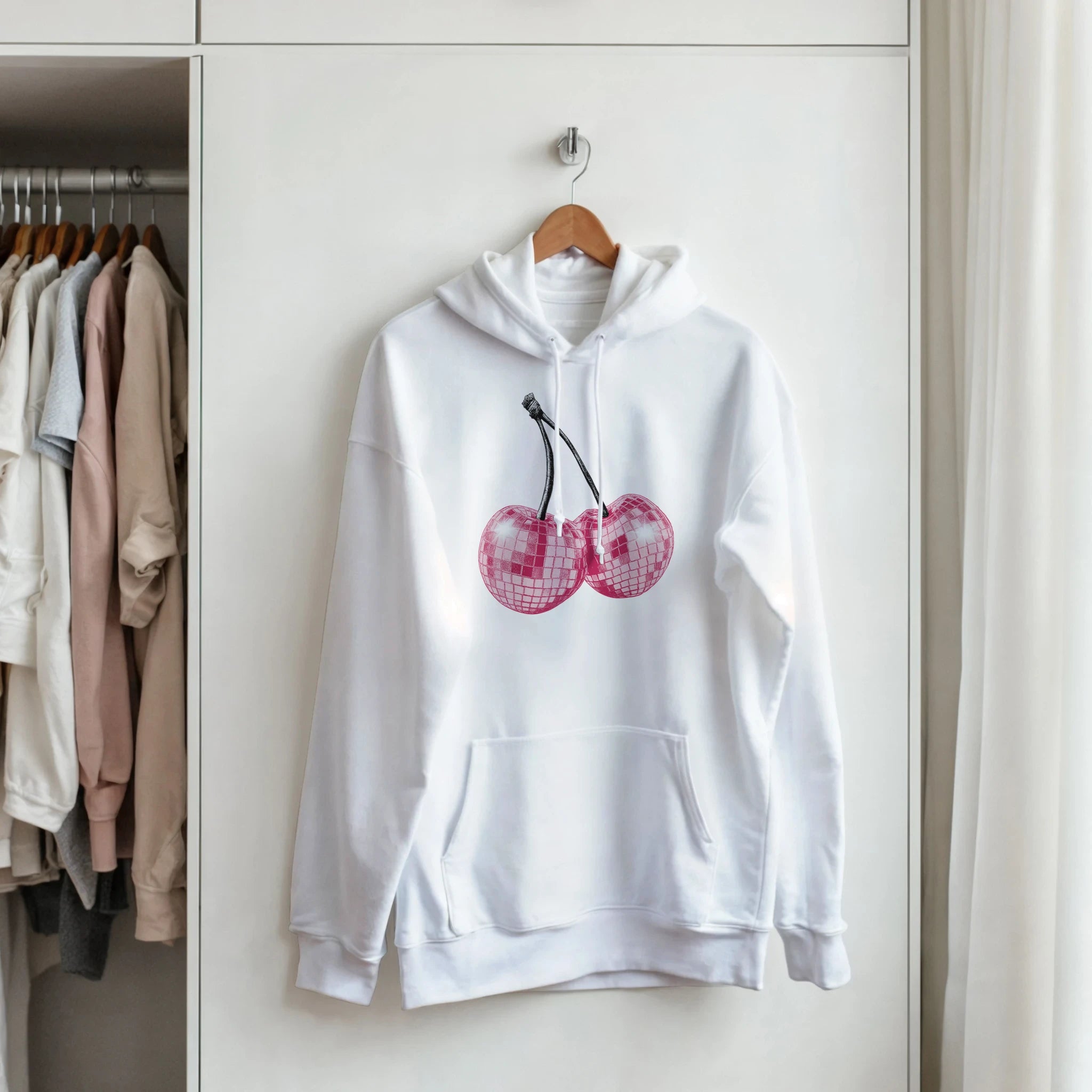 White hoodie with pink glitter ball cherries graphic and front pouch pocket.