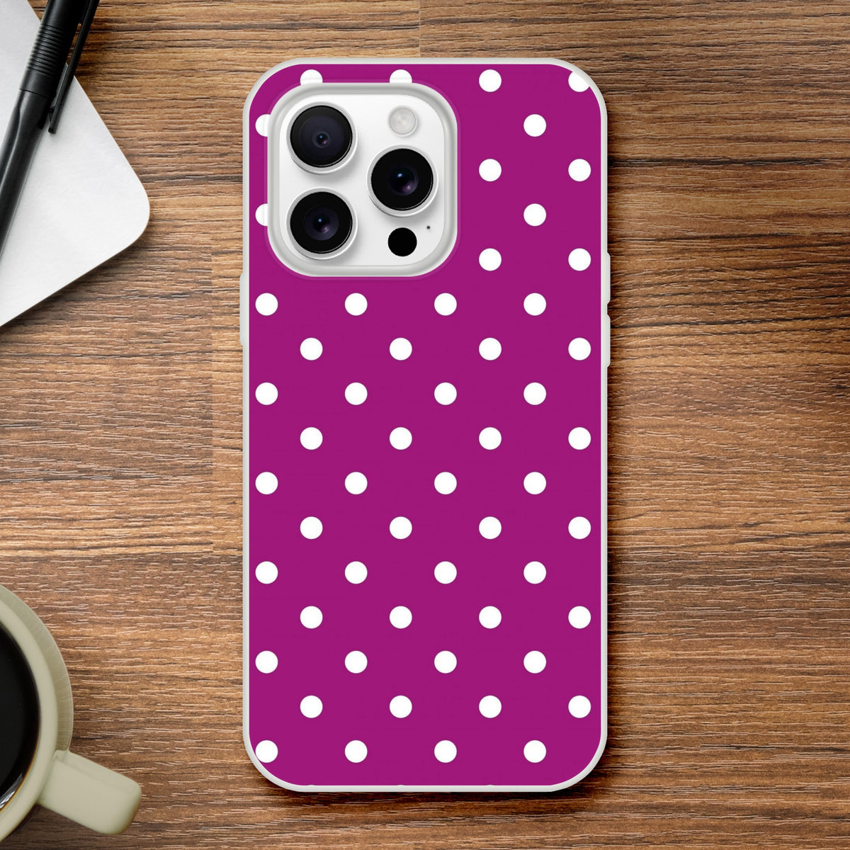 Retro purple and white polka dot iPhone case with matte finish and shock-absorbing TPU protection on a wooden desk.
