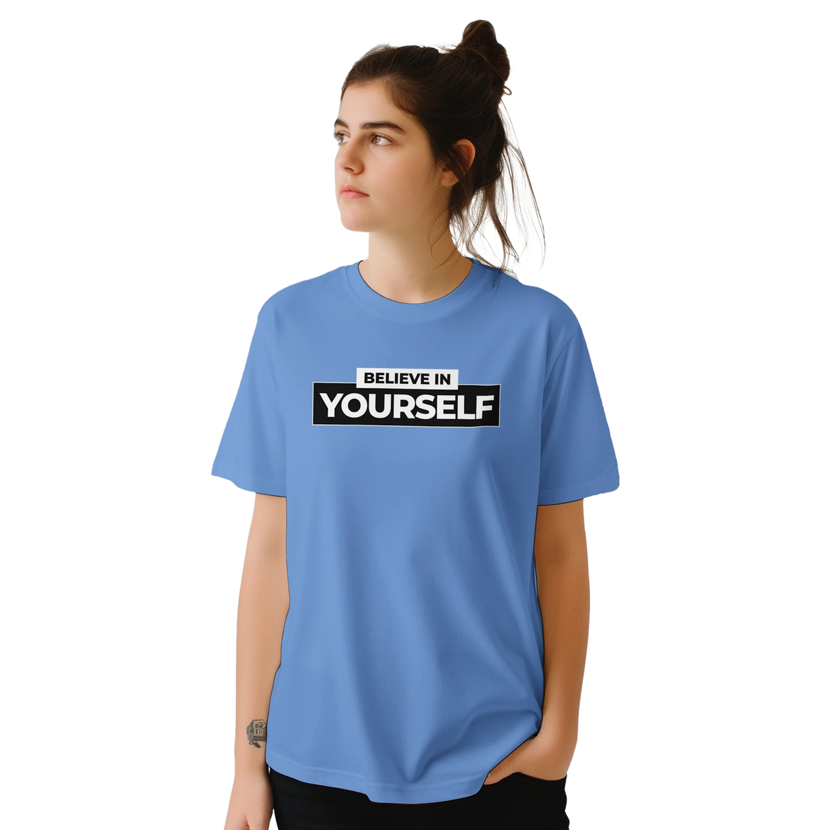 Woman wearing a blue Believe In Yourself T-shirt with bold retro slogan.