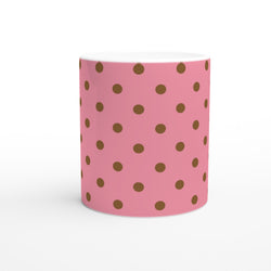 Pink ceramic mug featuring brown polka dots. Retro spotty coffee cup design perfect for daily coffee, tea, or office decor.