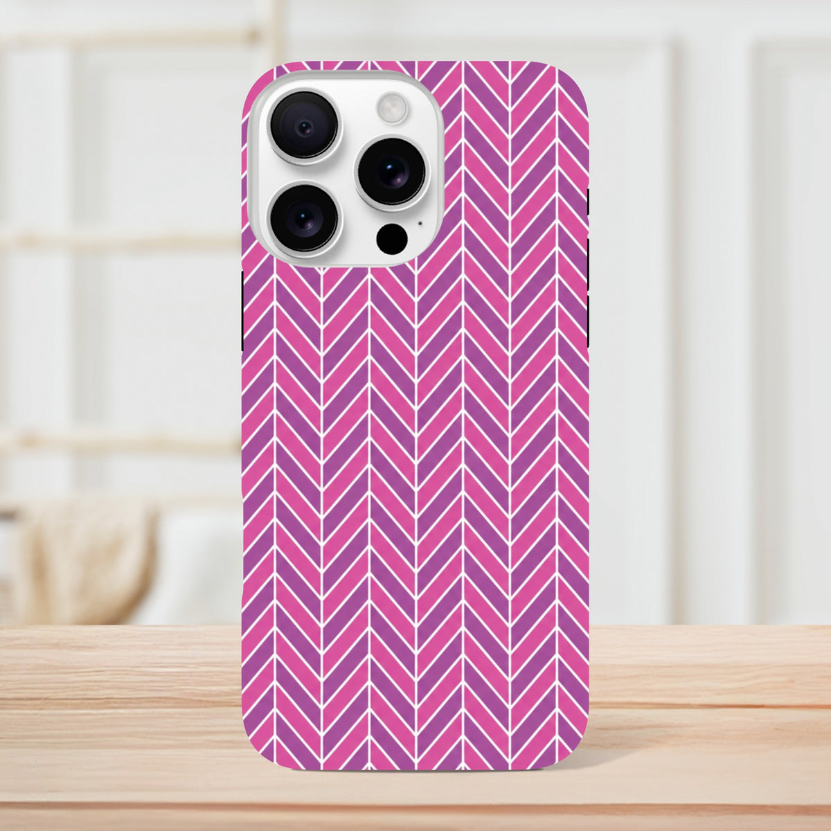 Pink herringbone geometric iPhone case with shock-absorbing TPU and reinforced frame for daily impact resistance.