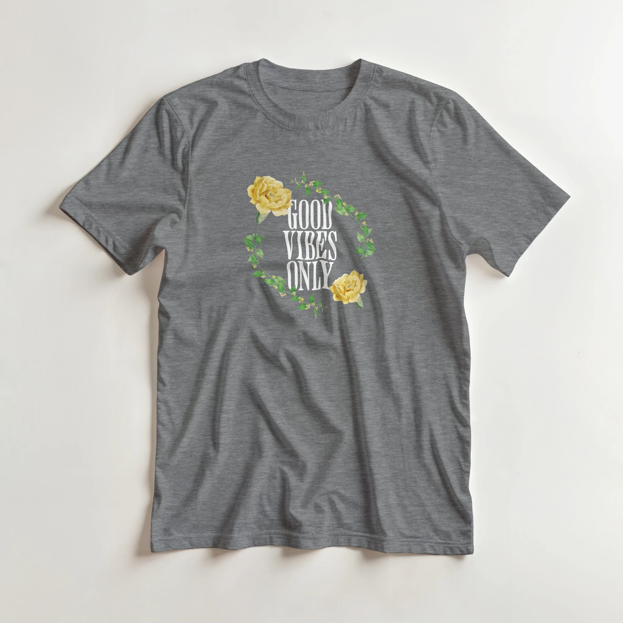 Gray women's graphic tee with white Good Vibes Only vertical text inside a green leafy wreath and yellow roses.