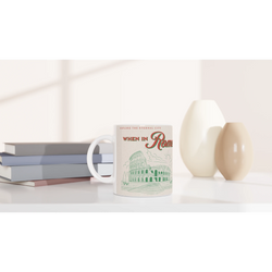 Vintage Rome mug with retro postcard art and Colosseum illustration, white ceramic mug on a desk.