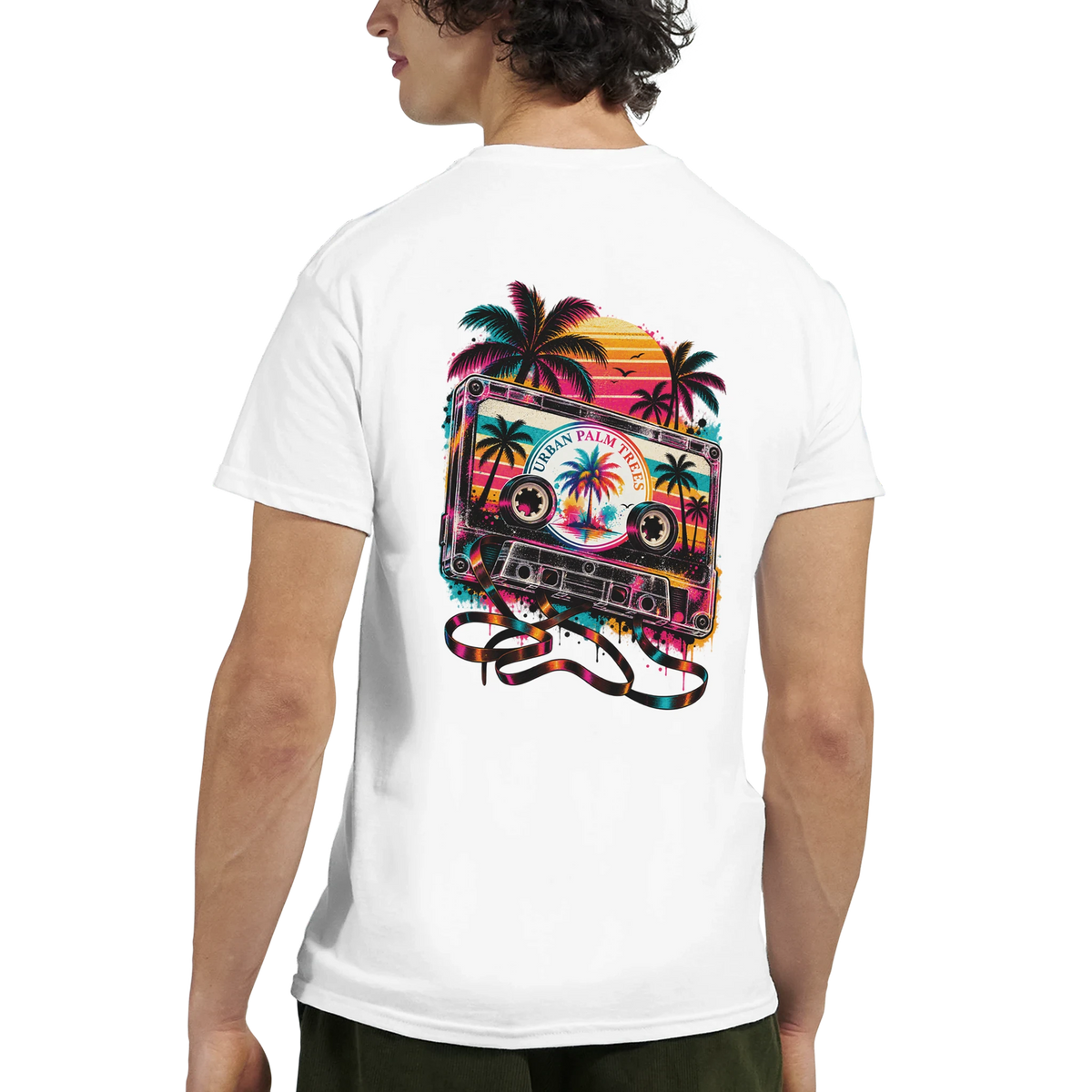 White men's t-shirt back featuring retro cassette tape graphic with palm trees and sunset. Vintage music nostalgia design.