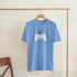 Light blue soft cotton-blend retro gamer graphic T-shirt with white pixel controller and colorful arcade bars.