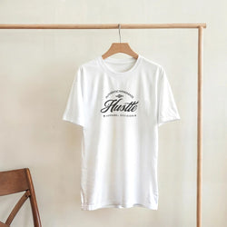 Hustle Men's Graphic T-Shirt in white cotton-blend with bold Hustle script logo, crew neck, sizes S-XL.