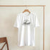 Hustle Men's Graphic T-Shirt in white cotton-blend with bold Hustle script logo, crew neck, sizes S-XL.