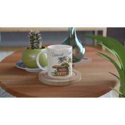 Retro postcard mug with island scene, vintage aesthetic coffee cup on a wooden table beside a cactus.