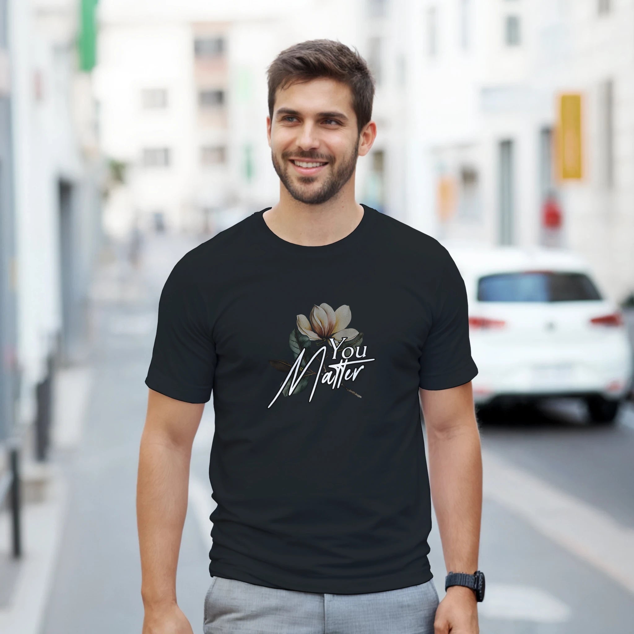 Man wearing You Matter slogan men's graphic tee on black soft cotton blend shirt with floral design.