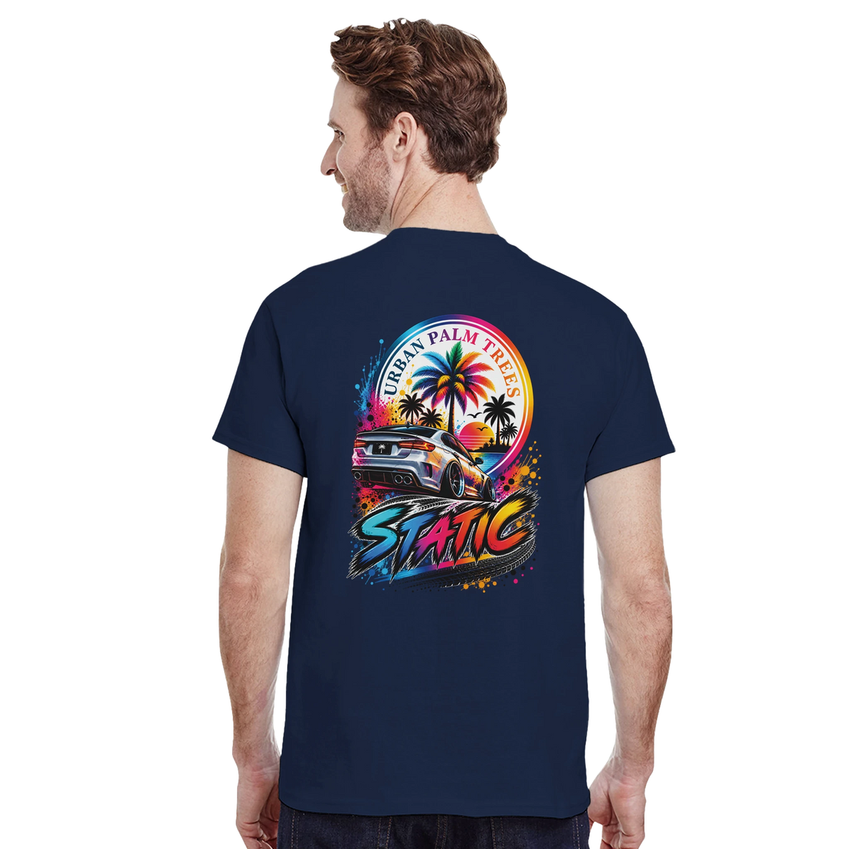 Man wearing navy Static petrolhead t-shirt back with modified car and palm trees graphic. Modified car culture aesthetic.