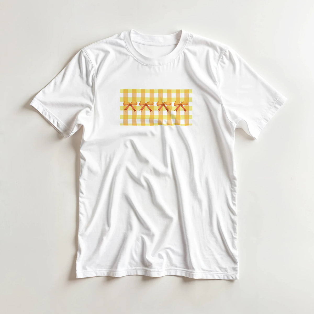 Cute yellow bow gingham T-shirt for women, white tee with yellow gingham rectangle and orange bows on front.