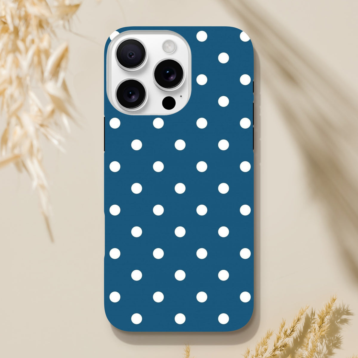 Navy blue and white polka dot tough iPhone case with opaque gloss finish and precise camera cutouts for iPhone 13-16 models.
