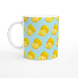 Pastel blue ceramic mug featuring a bright yellow whole and sliced lemon pattern for summer coffee or tea.