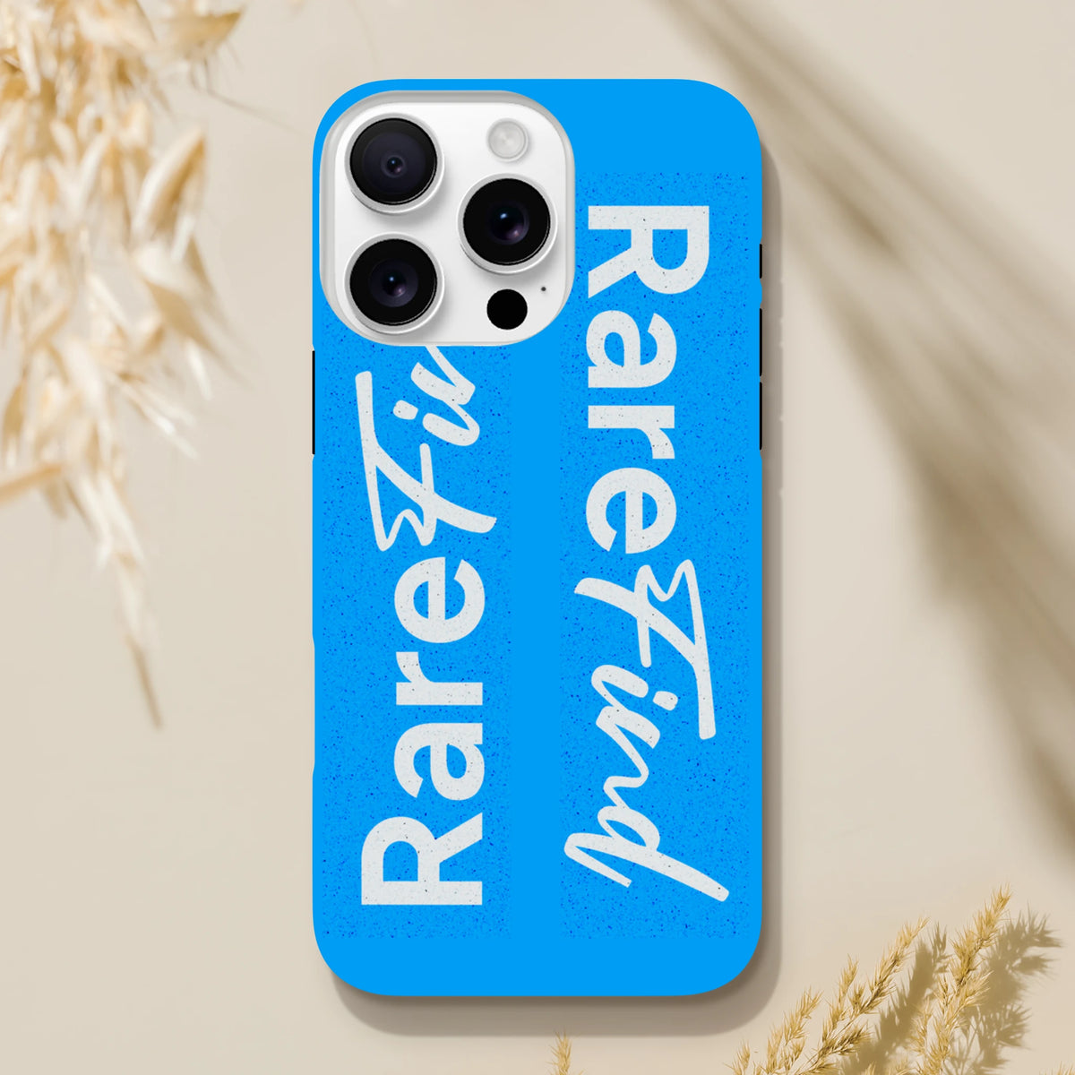 Blue iPhone case with white "Rare Find" slogan text in block and script fonts, featuring a tough streetwear design for iPhone 13-16.