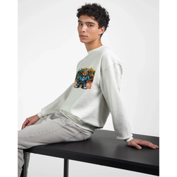 Man wearing white Urban Teddy Bear graphic sweatshirt with colorful bear artwork, seated at a table.