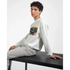Man wearing white Urban Teddy Bear graphic sweatshirt with colorful bear artwork, seated at a table.