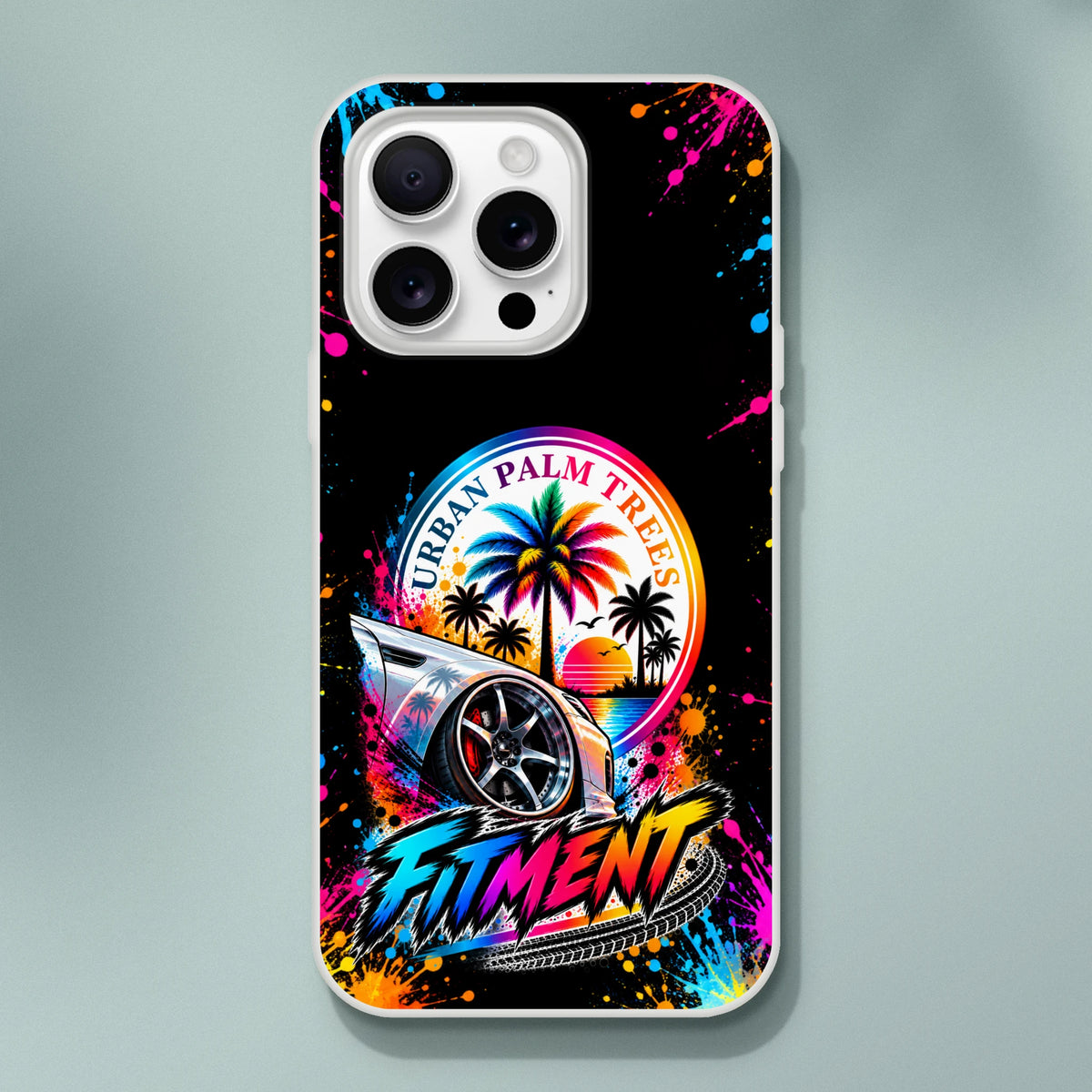 iPhone case featuring lowered car with palm trees, sunset, and colorful "Urban Palm Trees" and "Fitment" graphics on black splatter background.