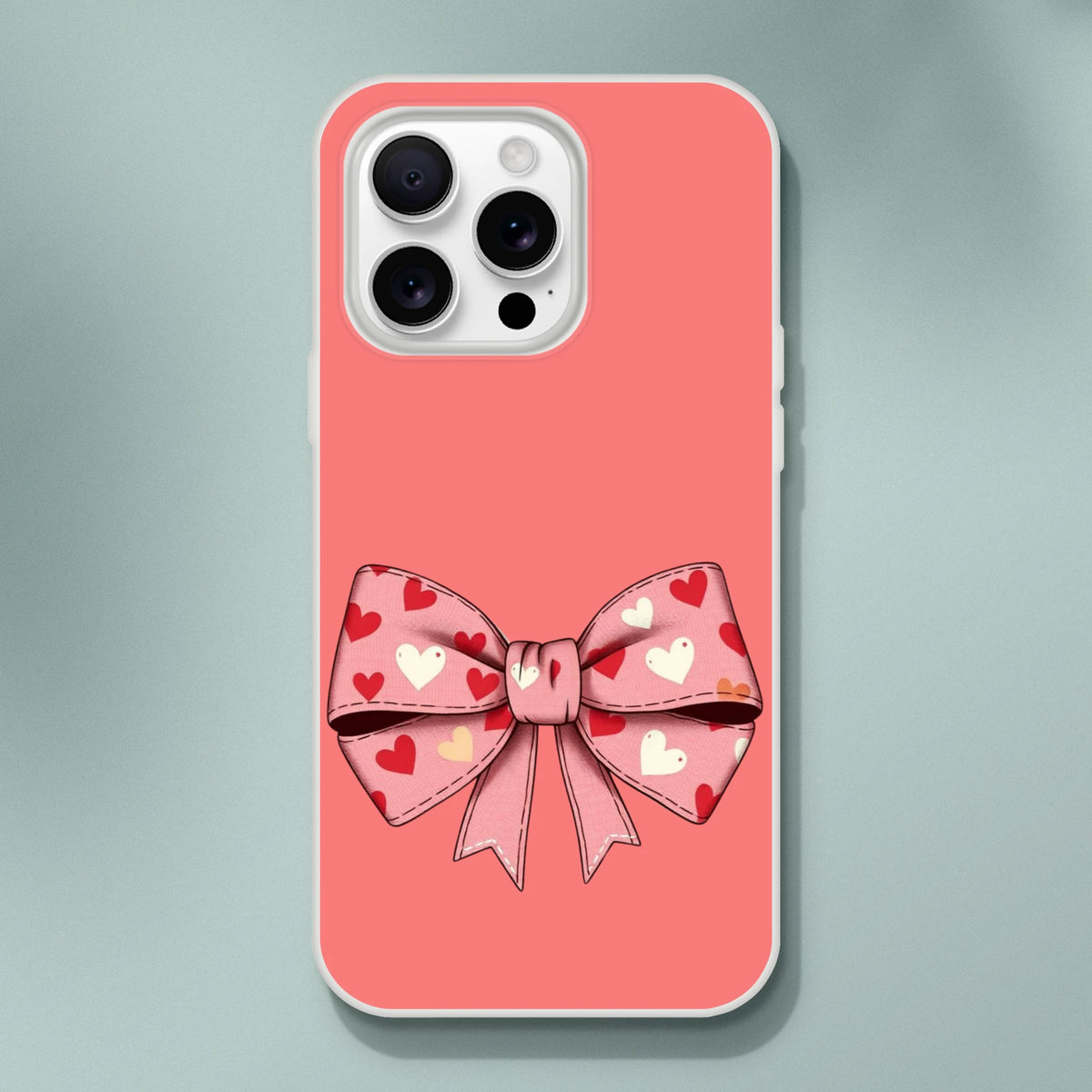 Cute pink and cream bow iPhone case for 13–16, pastel coquette aesthetic with heart bow design.