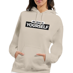 Beige Believe In Yourself hoodie with bold black slogan, worn by a woman.
