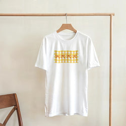 White T-shirt with a yellow gingham bow print, hanging on a wooden clothing rack.
