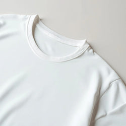 White women's crew-neck T-shirt in a soft cotton blend; neckline close-up.