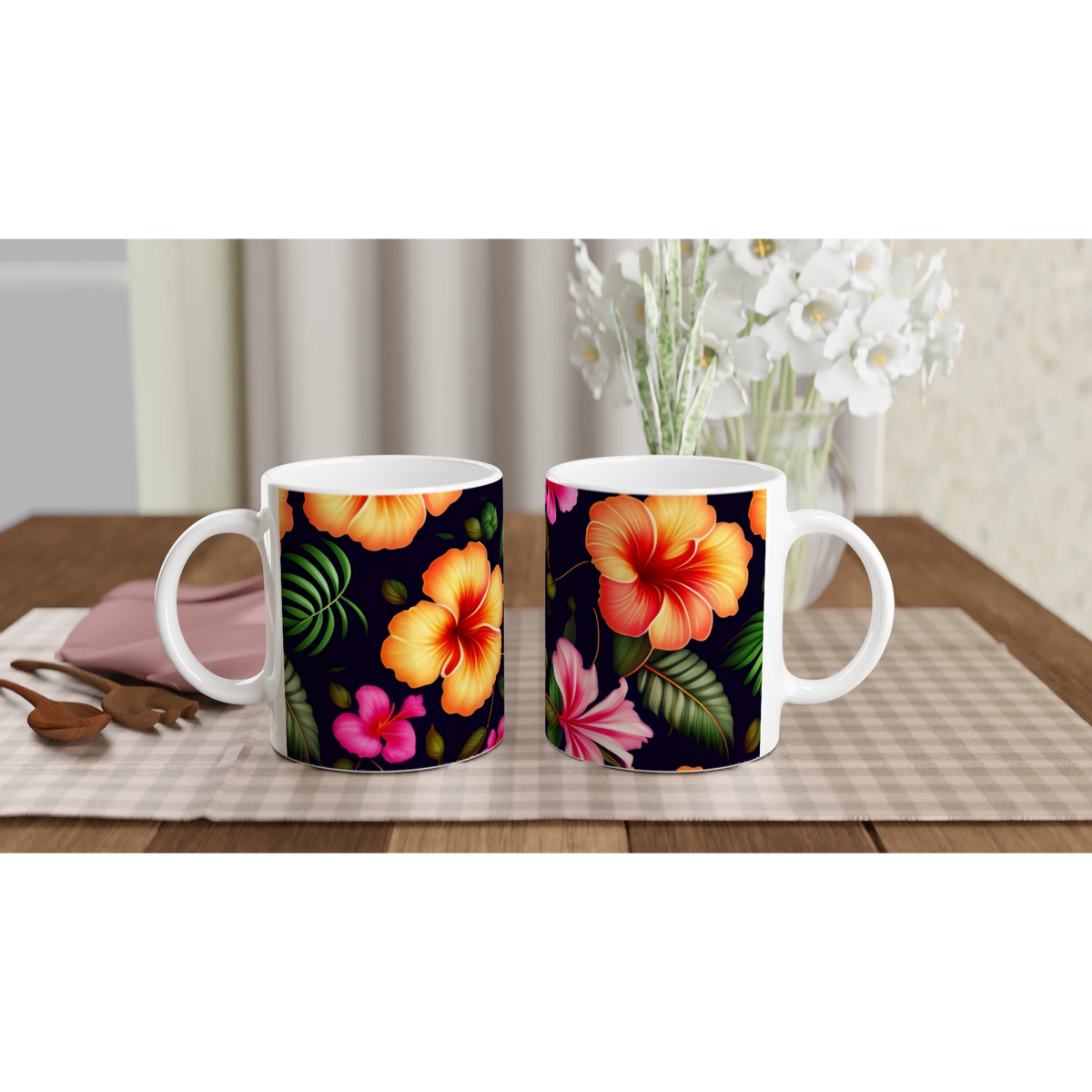 Two tropical hibiscus mugs with vibrant orange and pink blossoms on a black background, set on a checkered table.