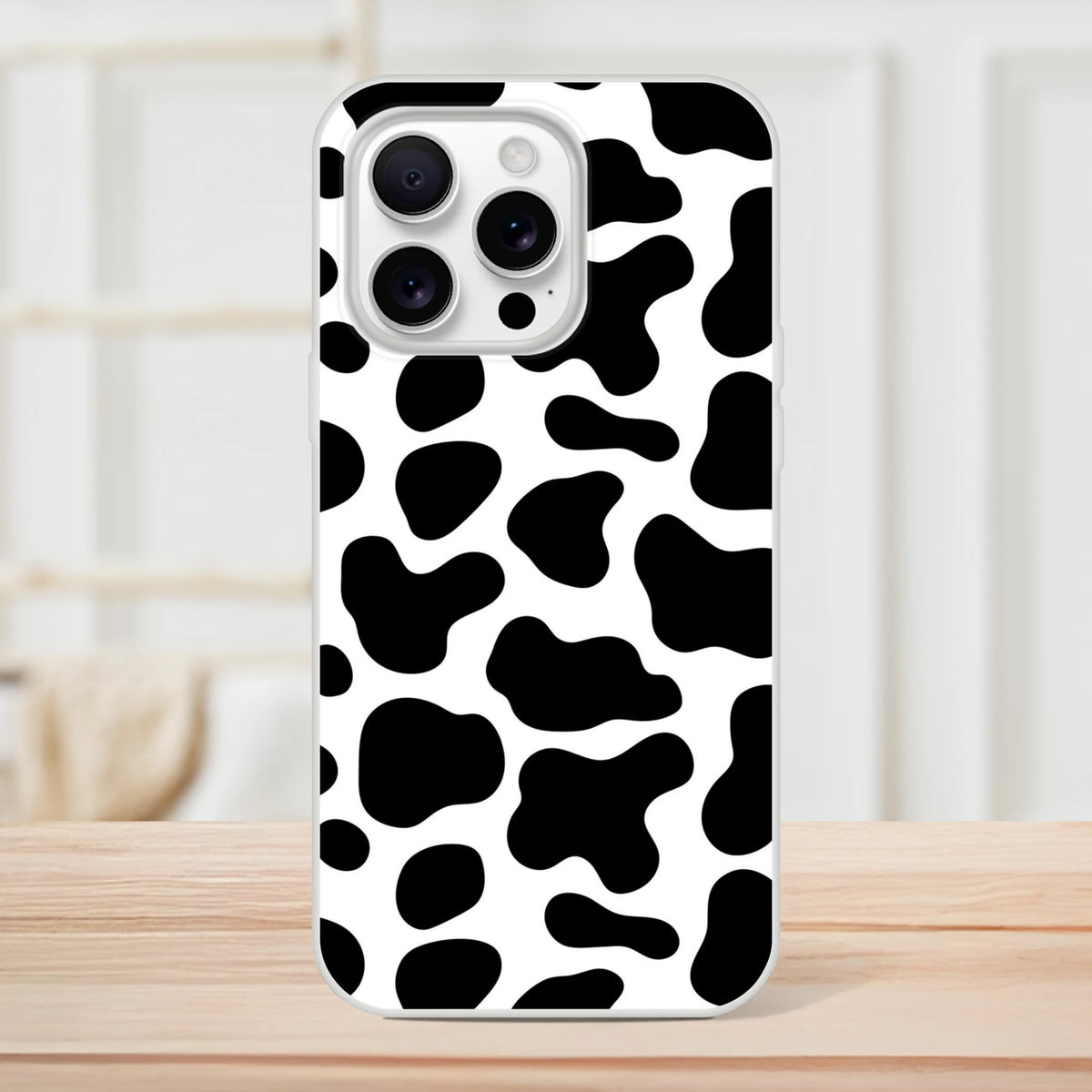 Black & White Cow Print iPhone Case for iPhone 13–16 with bold Y2K animal pattern.