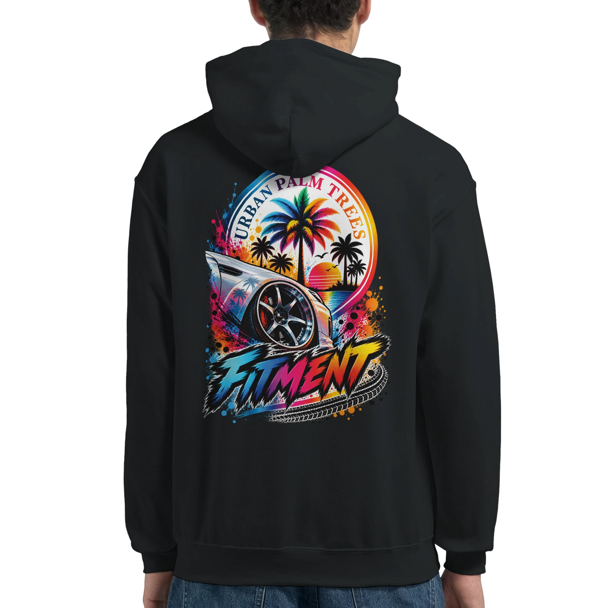 Black hoodie back featuring colorful "Fitment" graphic with modified car wheel, urban palm trees, and retro sunset design.