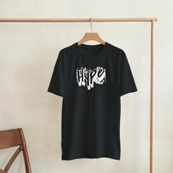 Black graffiti graphic tee on wooden hanger, urban streetwear for men.