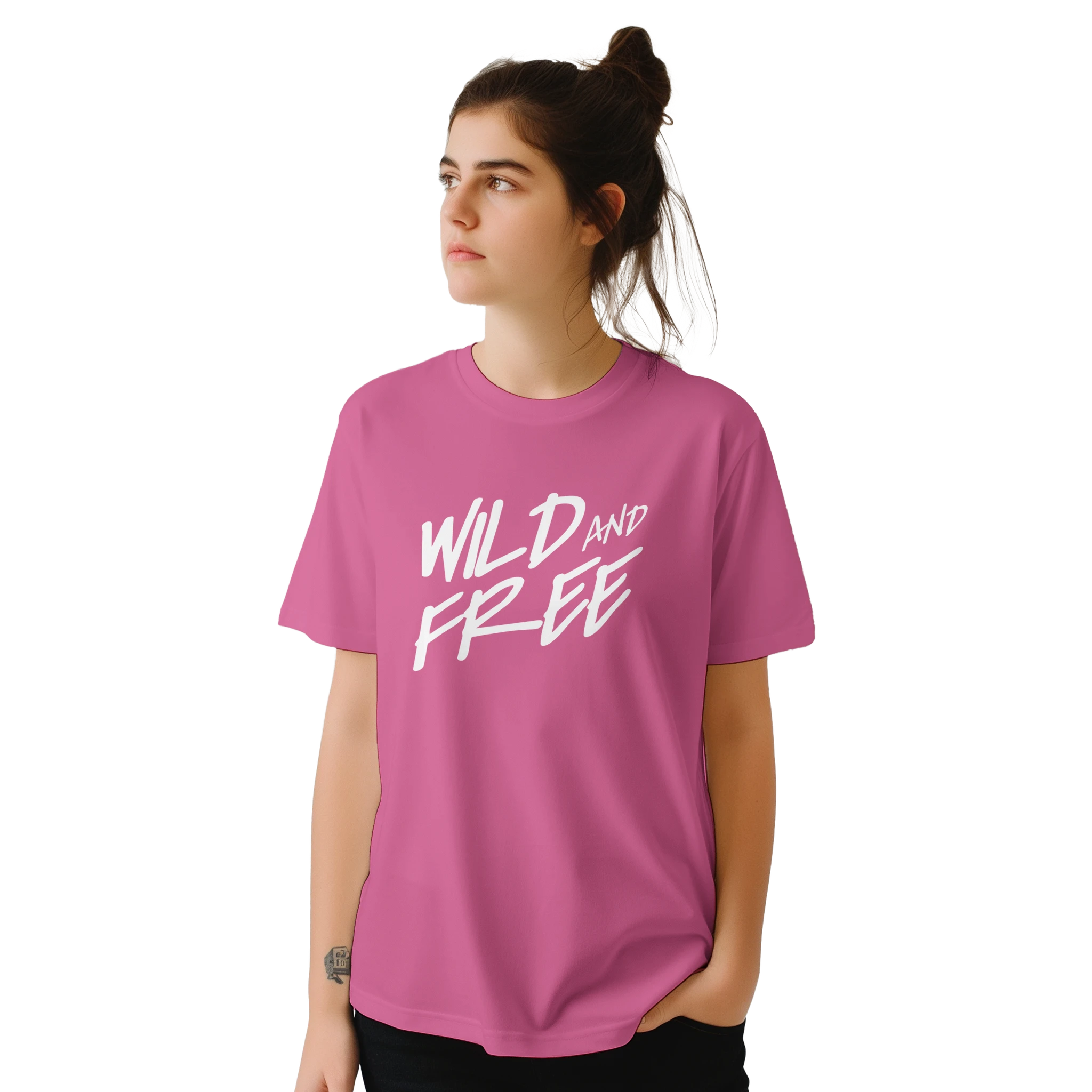 Woman wearing pink Cute Wild And Free T‑Shirt with bold white retro slogan.
