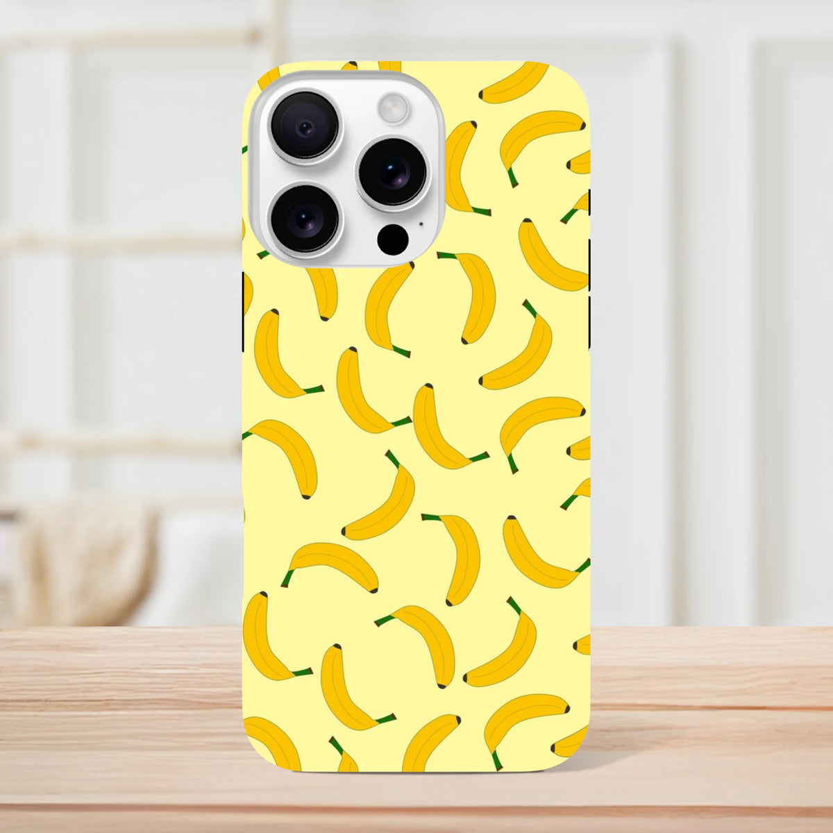 Yellow banana pattern iPhone case featuring cute fruit design for tough protection and playful style on compatible models.