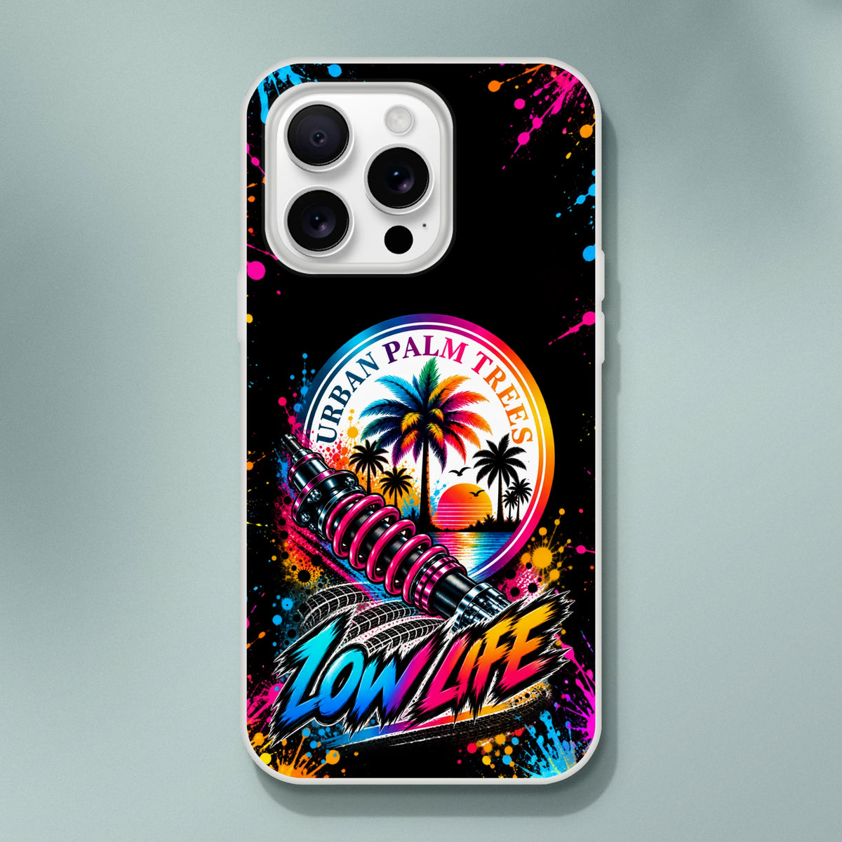 Low Life car culture iPhone case featuring colorful palm trees, pink shock absorber, and graffiti text on a black splatter background.