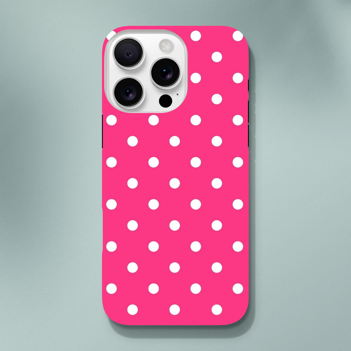 Hot pink and white polka dot tough iPhone case with dual-layer shock absorption for rugged protection and wireless charging compatibility.