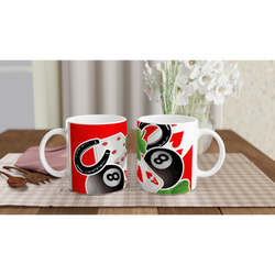 Two Lucky Casino ceramic mugs with dice, playing cards and 8-ball designs on a table with a checkered placemat.