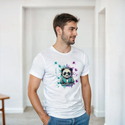 Man wearing white t-shirt with colorful DJ panda graphic wearing sunglasses and headphones against paint splatter background.