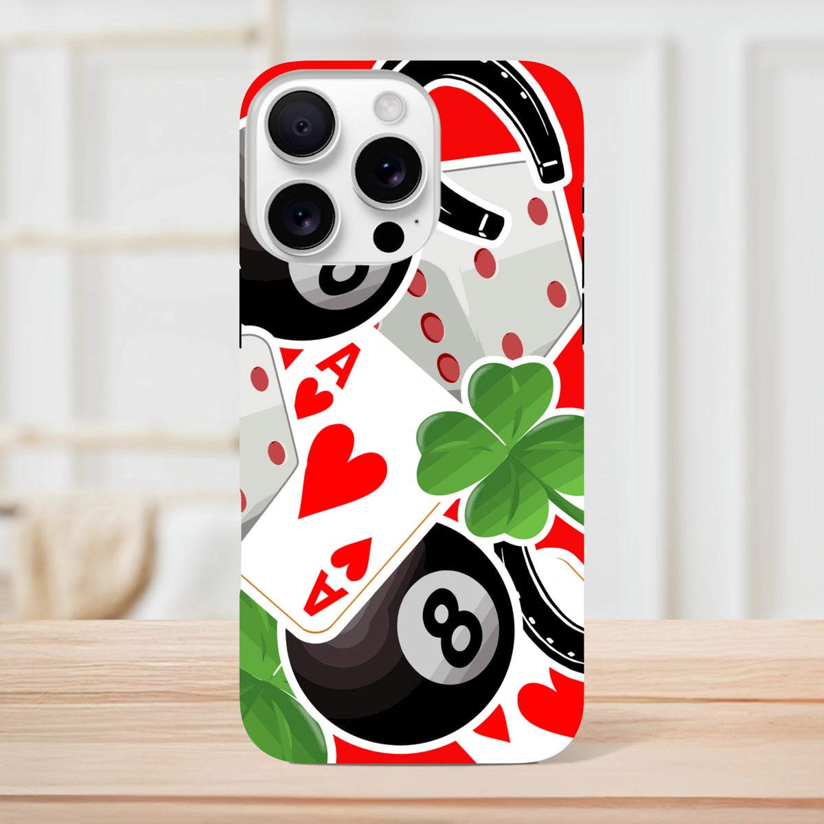 Tough iPhone case featuring lucky charm sticker design with ace of hearts, four-leaf clover, horseshoe, and 8-ball graphics on red background.