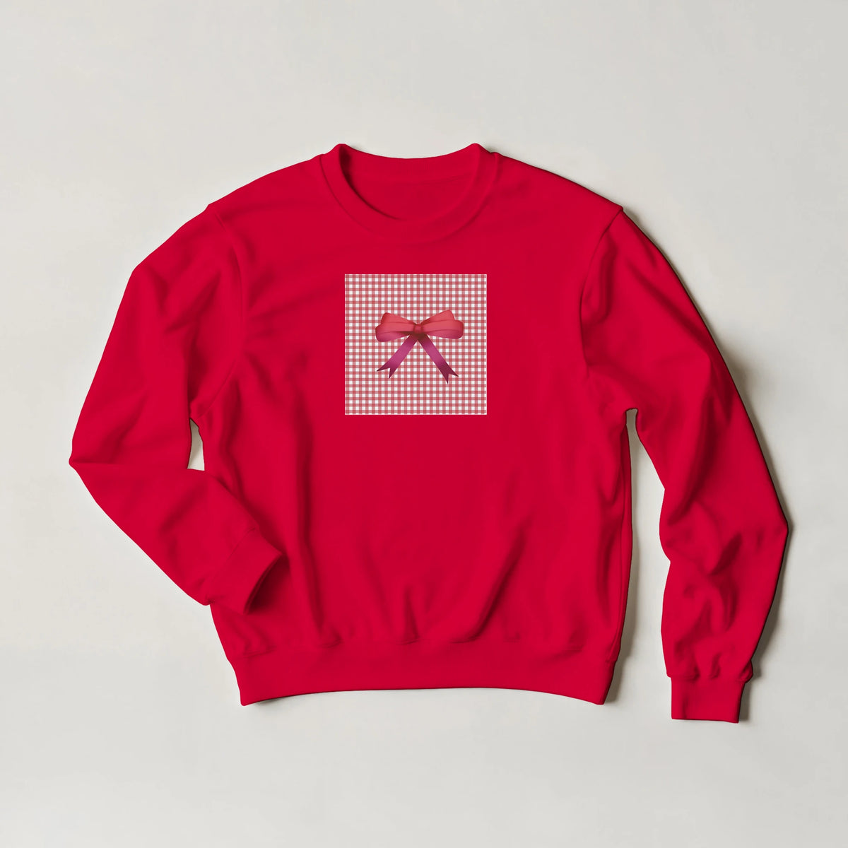 Red pullover sweatshirt featuring a pink gingham square and bow graphic, embodying a cute coquette aesthetic for women.